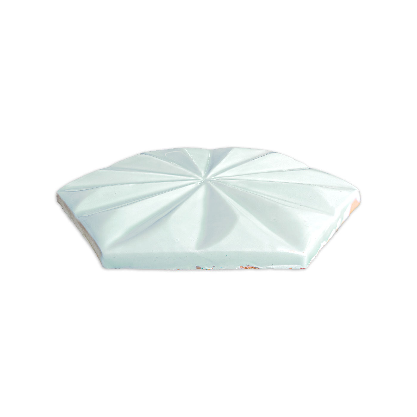 Spearmint green hexagonal solid tile by Clay Imports with a glossy, faceted geometric starburst pattern.