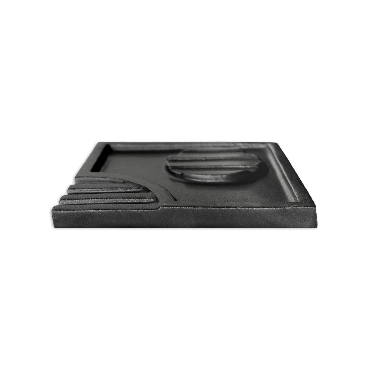 Black suede-finish decorative tile by Clay Imports, featuring Tacón-style stepped ridges and a recessed circle, viewed from the side.