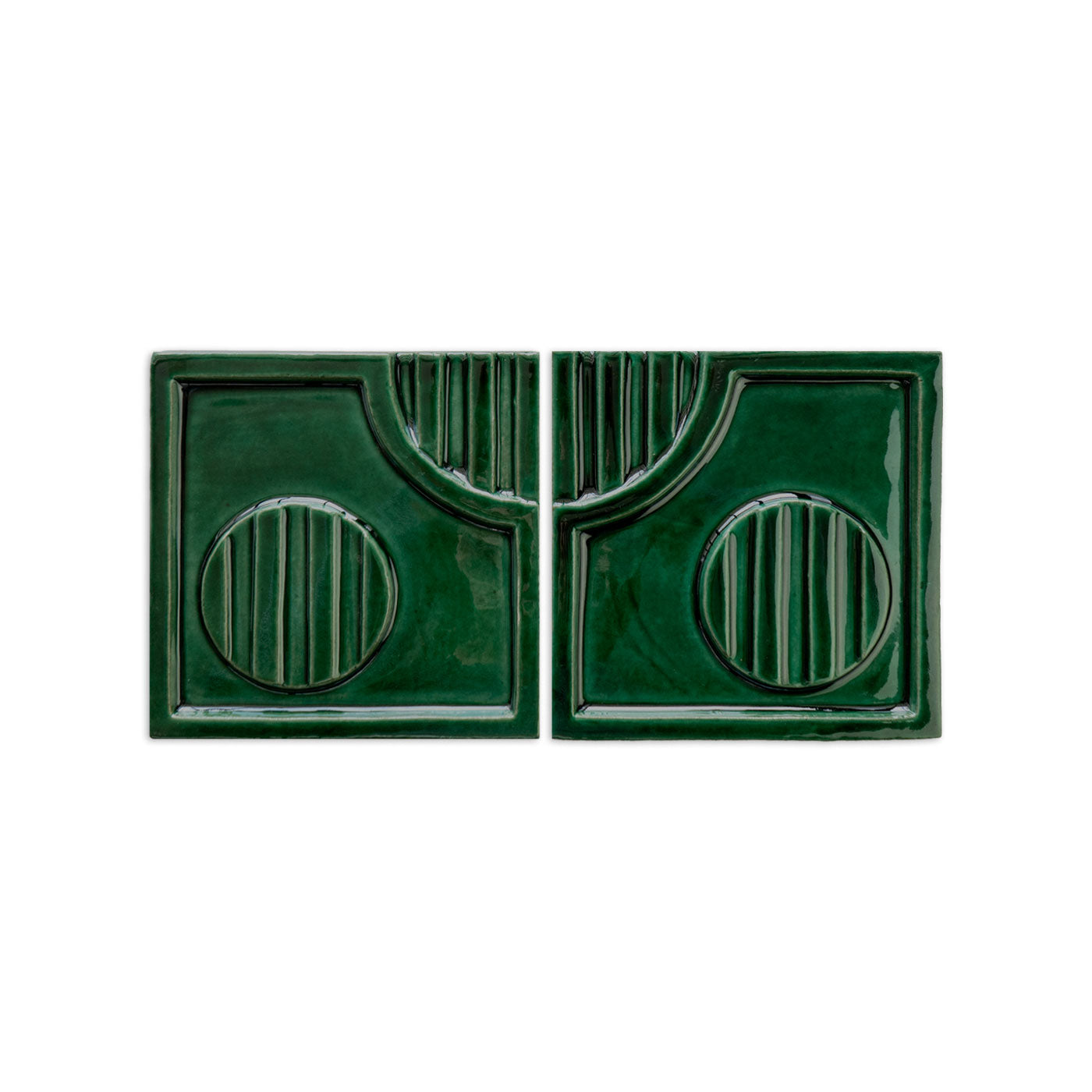 Pair of forest green glazed ceramic tiles by Clay Imports, with a symmetrical geometric relief pattern and glossy finish.