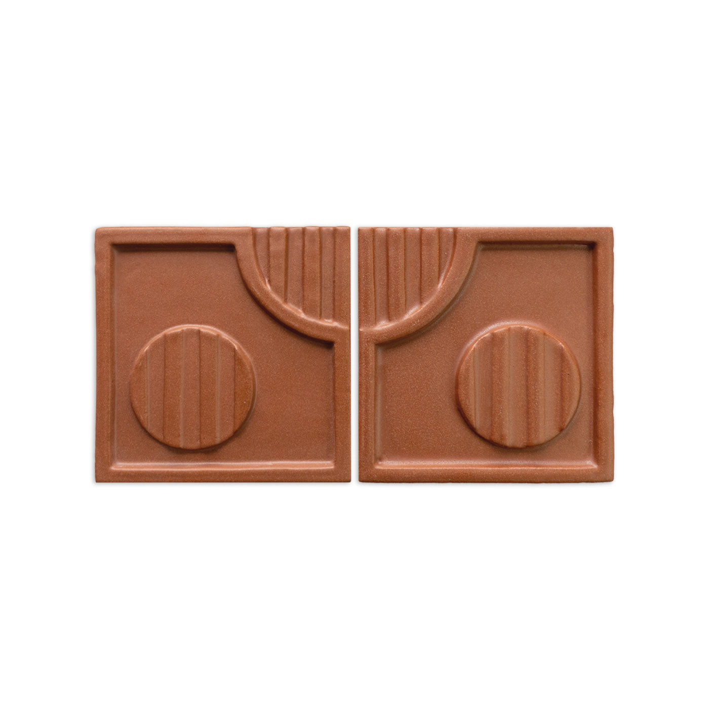 Pair of Tacón Mamey 6x6 terracotta tiles by Clay Imports, with abstract geometric relief patterns.