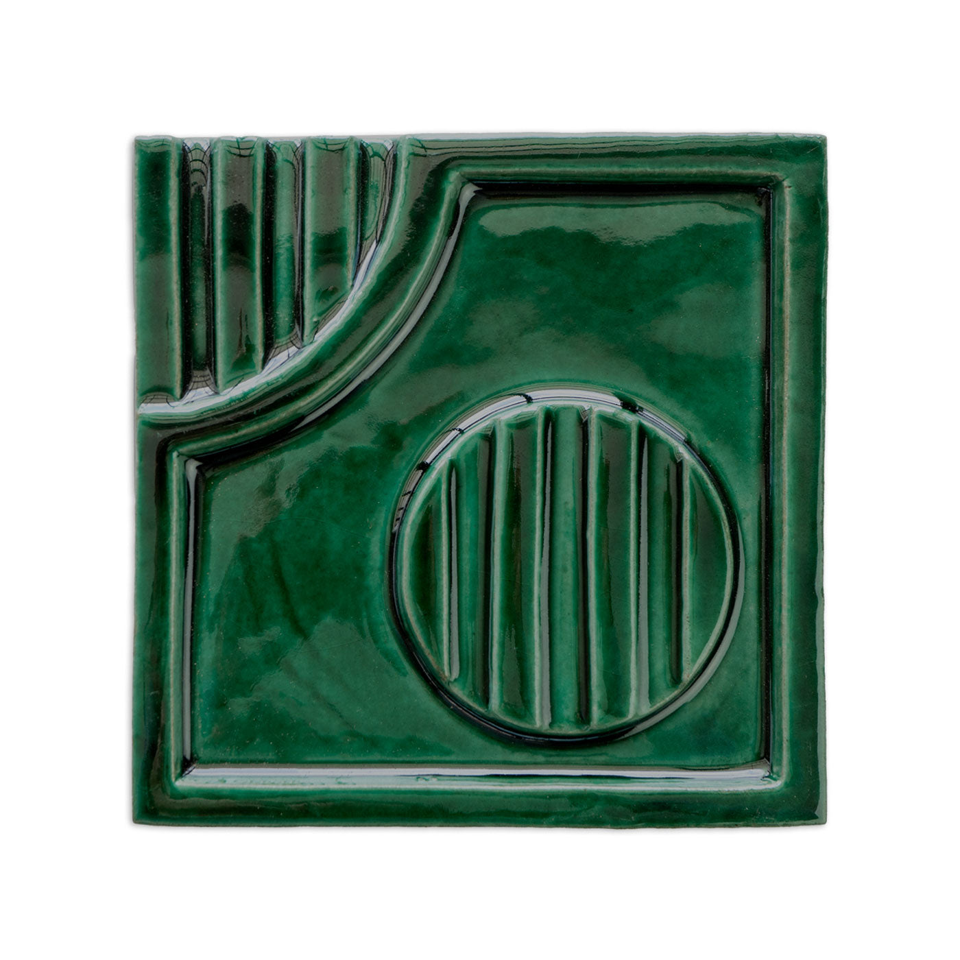 Green glazed tile by Clay Imports featuring geometric raised ridges and a circular pattern.