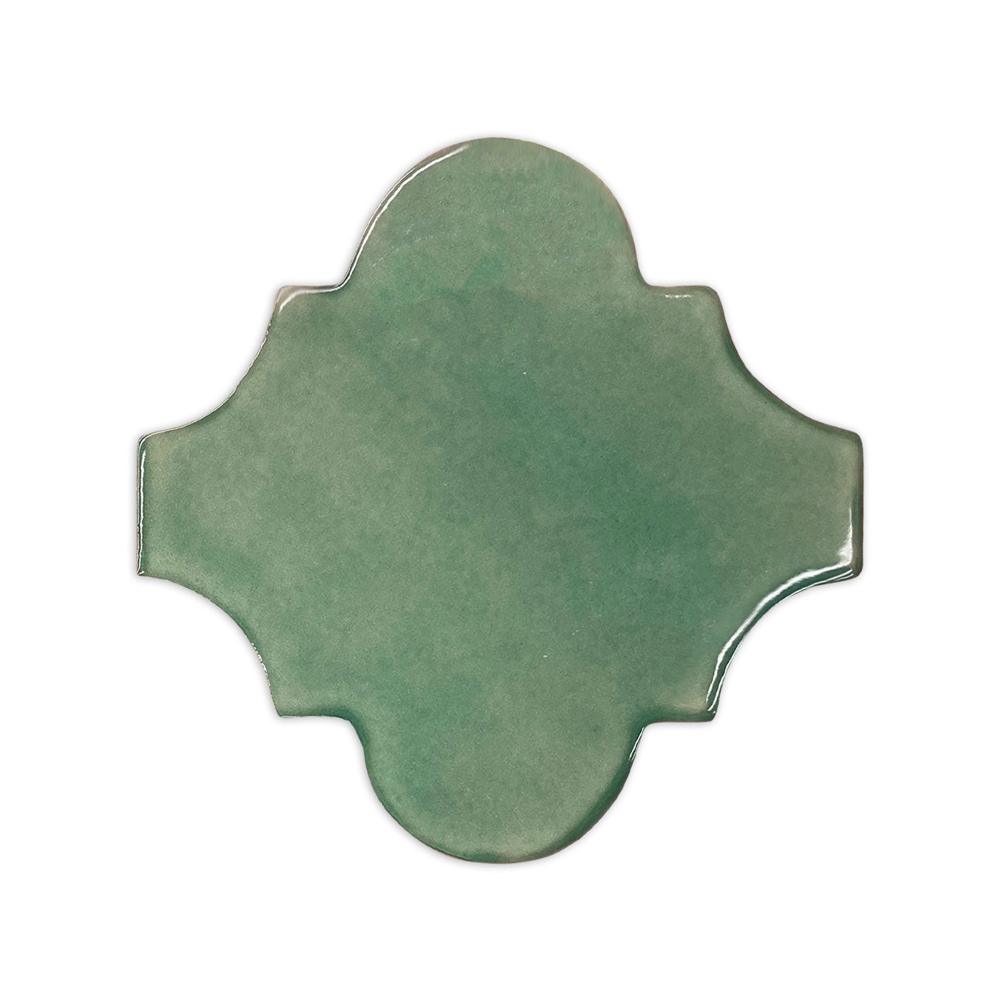 Green Espanola tile sample by Clay Imports, featuring a glossy finish and intricate quatrefoil shape.