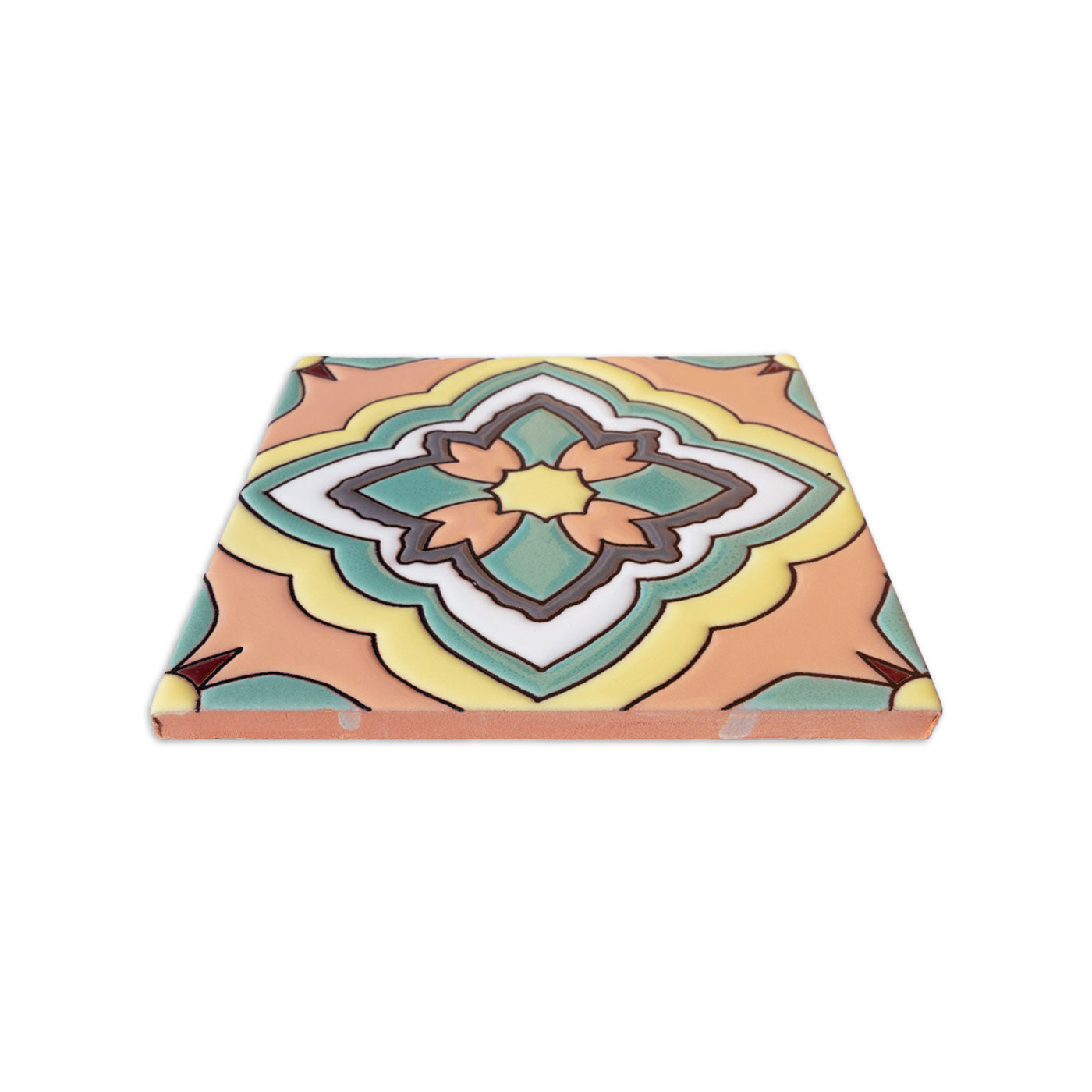 Square relief tile sample by Clay Imports with a multi-colored geometric pattern in mint, yellow, peach, and white.