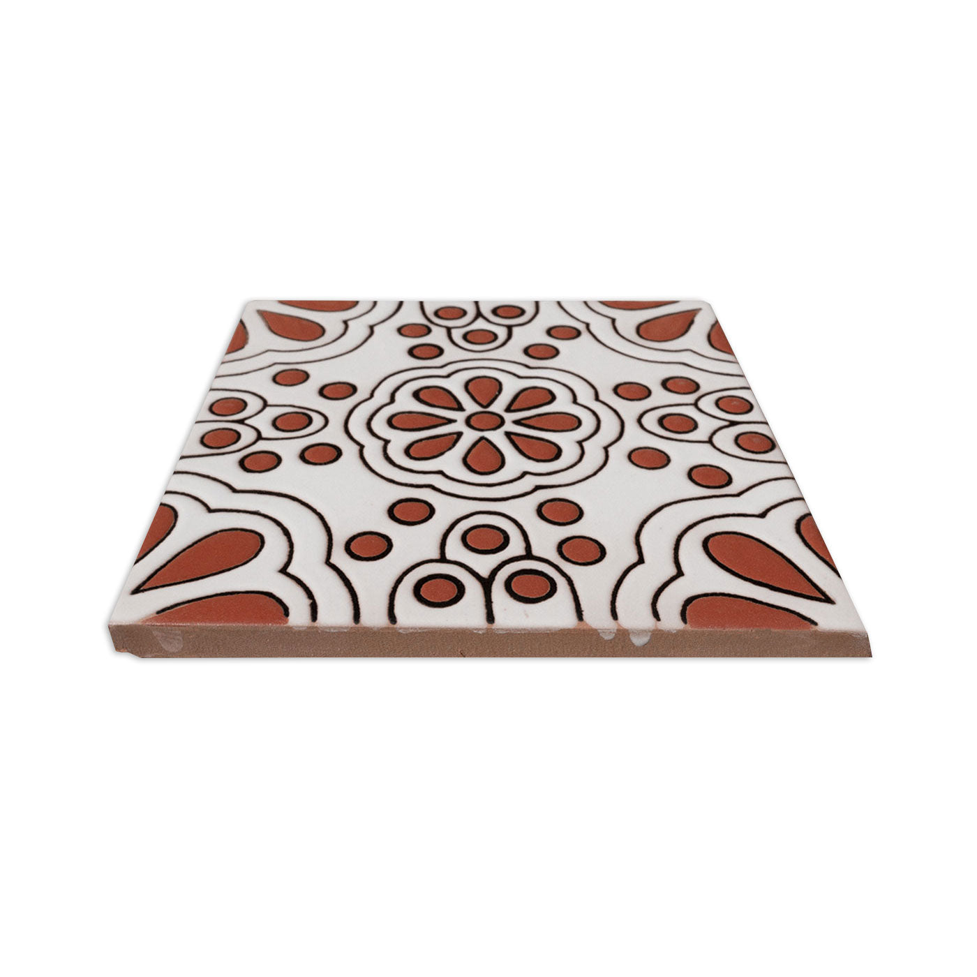 Sample tile with a white and terracotta floral relief pattern by Clay Imports, viewed at an angle.