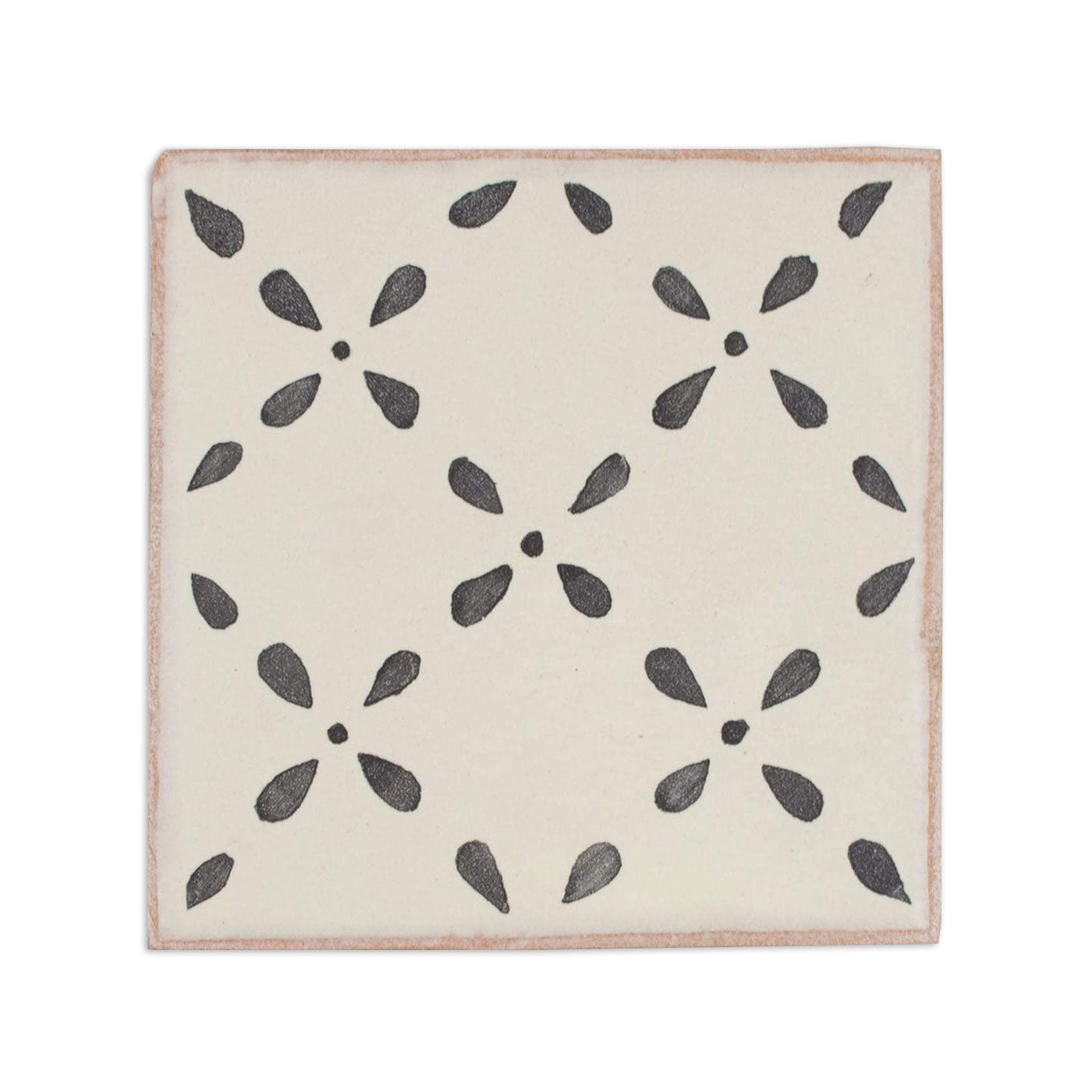 An off-white pattern tile with a dark gray crossdrop floral motif by Clay Imports, featuring reddish-brown edges.