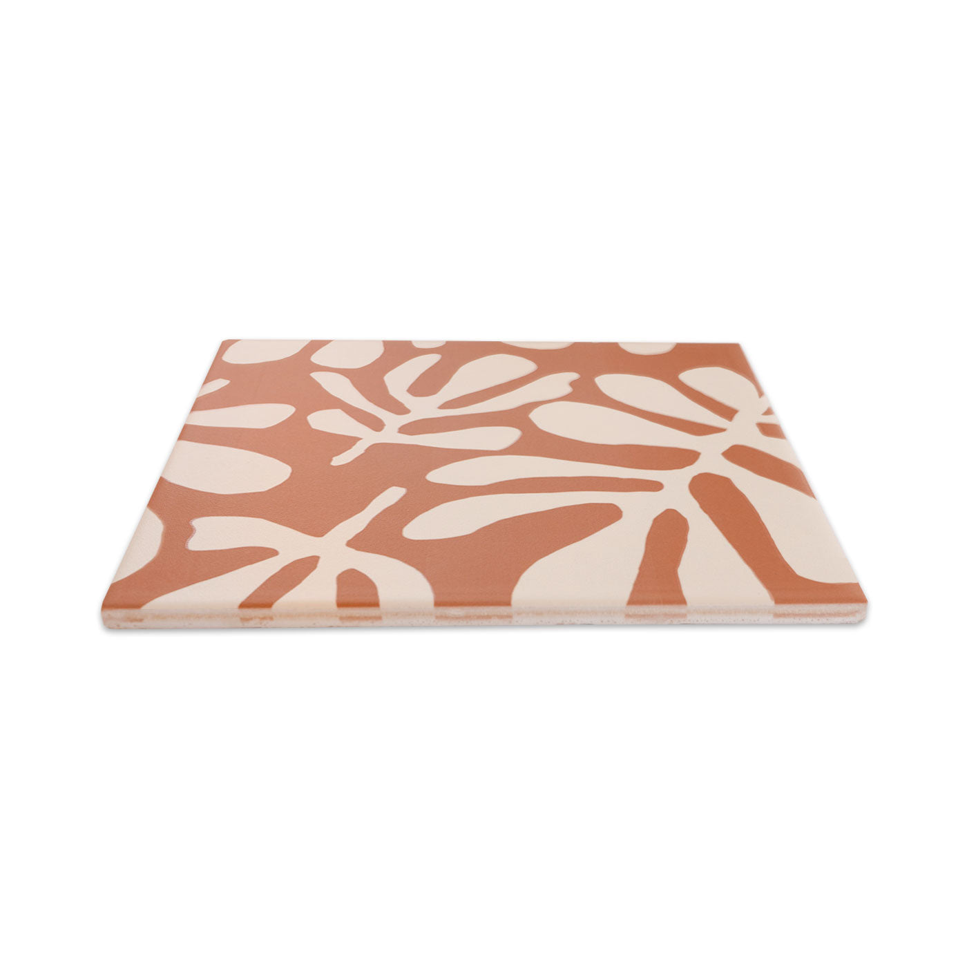 Rectangular pattern tile in terracotta and cream by Clay Imports, with an organic, abstract leaf pattern, viewed at an angle.