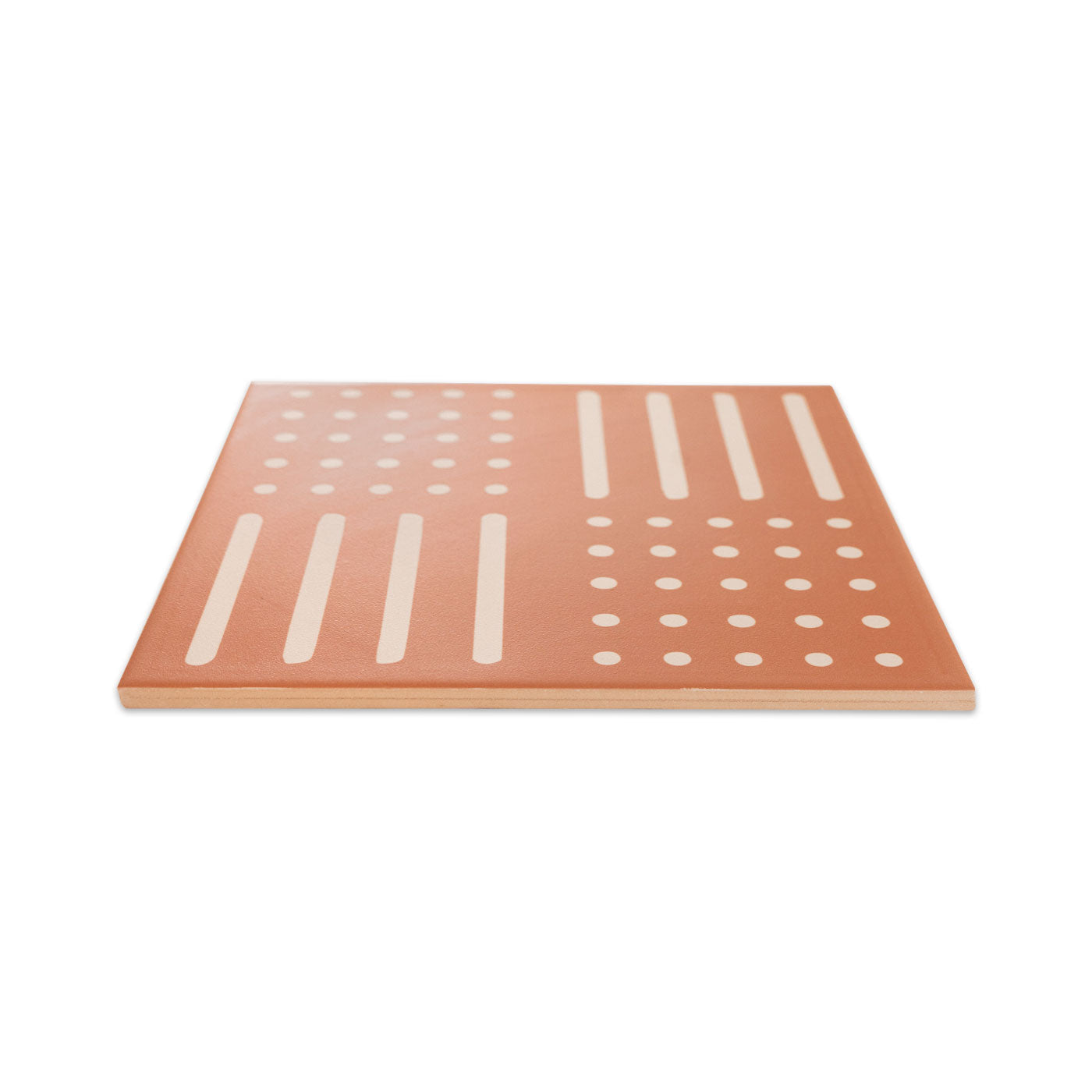 Terracotta pattern tile by Clay Imports featuring a geometric mudcloth-inspired design of white dots and lines.