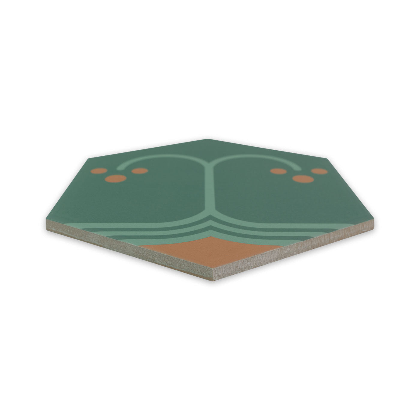 Green elongated hexagonal pattern tile by Clay Imports with light green tree design, orange dots, and visible brown edge.