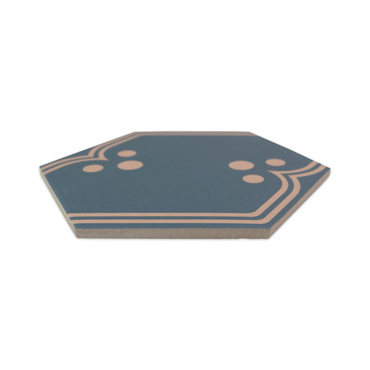Midnight blue-green pattern tile by Clay Imports with peach geometric lines and dots on an octagonal shape, viewed at an angle.