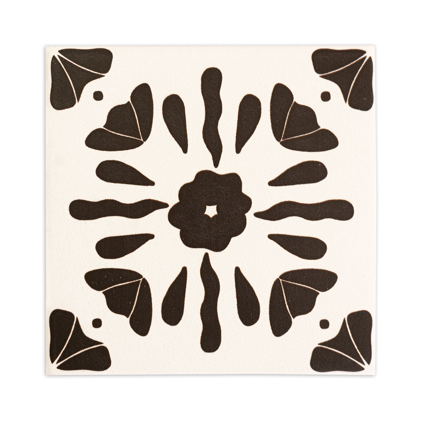 Black and white sample tile by Clay Imports with a central flower, star cutout, and abstract corner designs.