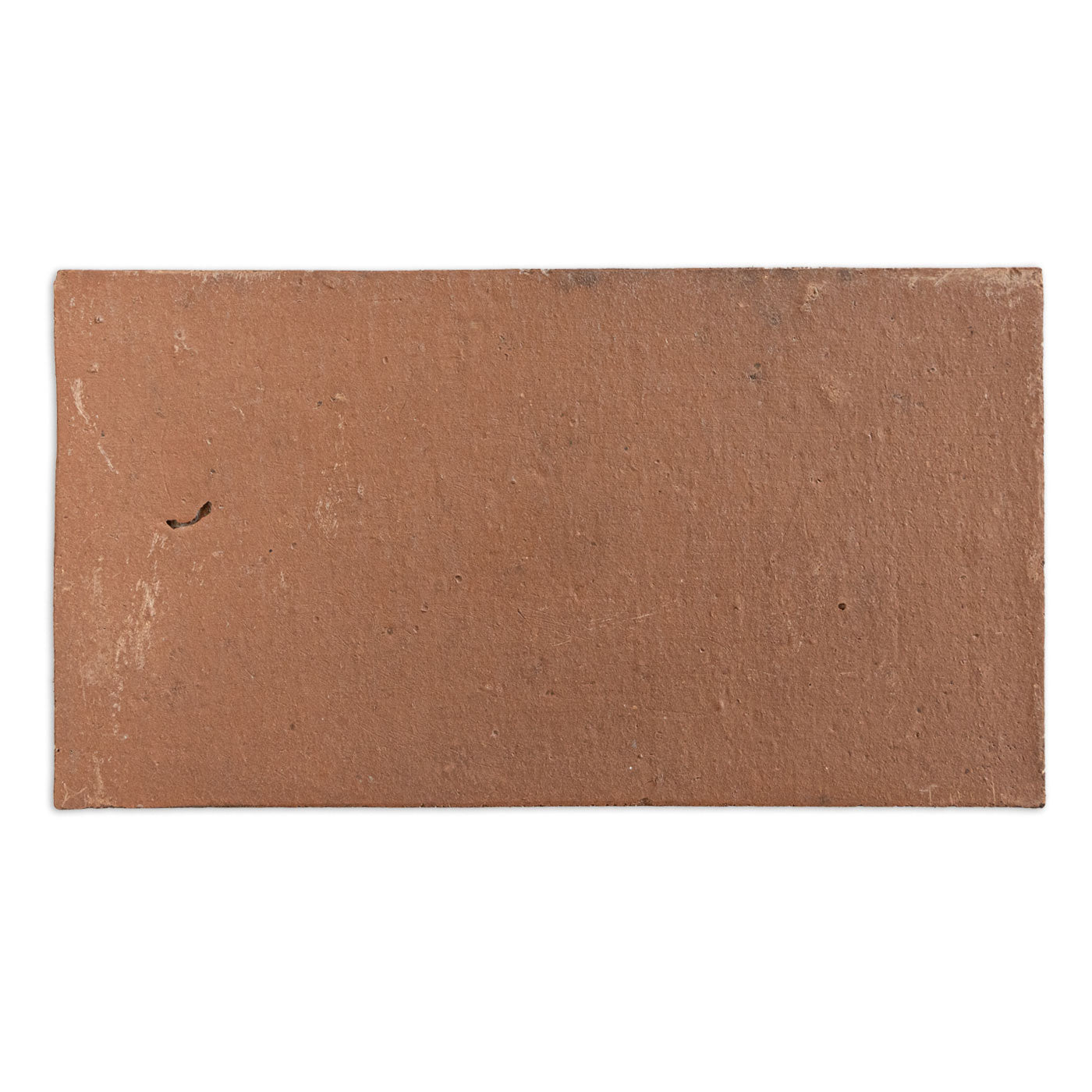 Reddish-brown rectangular Baked Thin Paver Sample by Clay Imports Pavers, with a rough, textured surface and subtle imperfections.