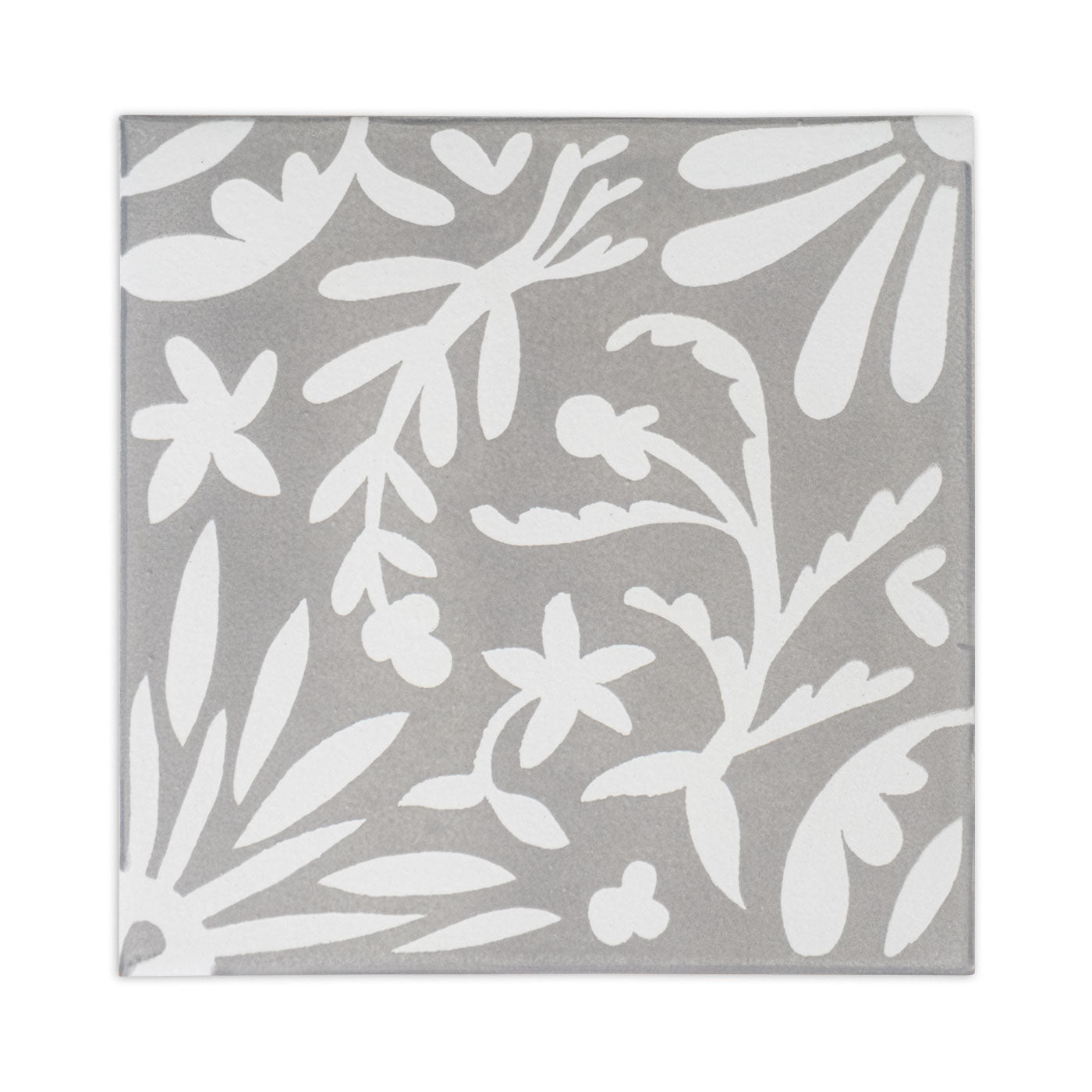 A gray square sample tile by Clay Imports with a white whimsical floral and botanical pattern.