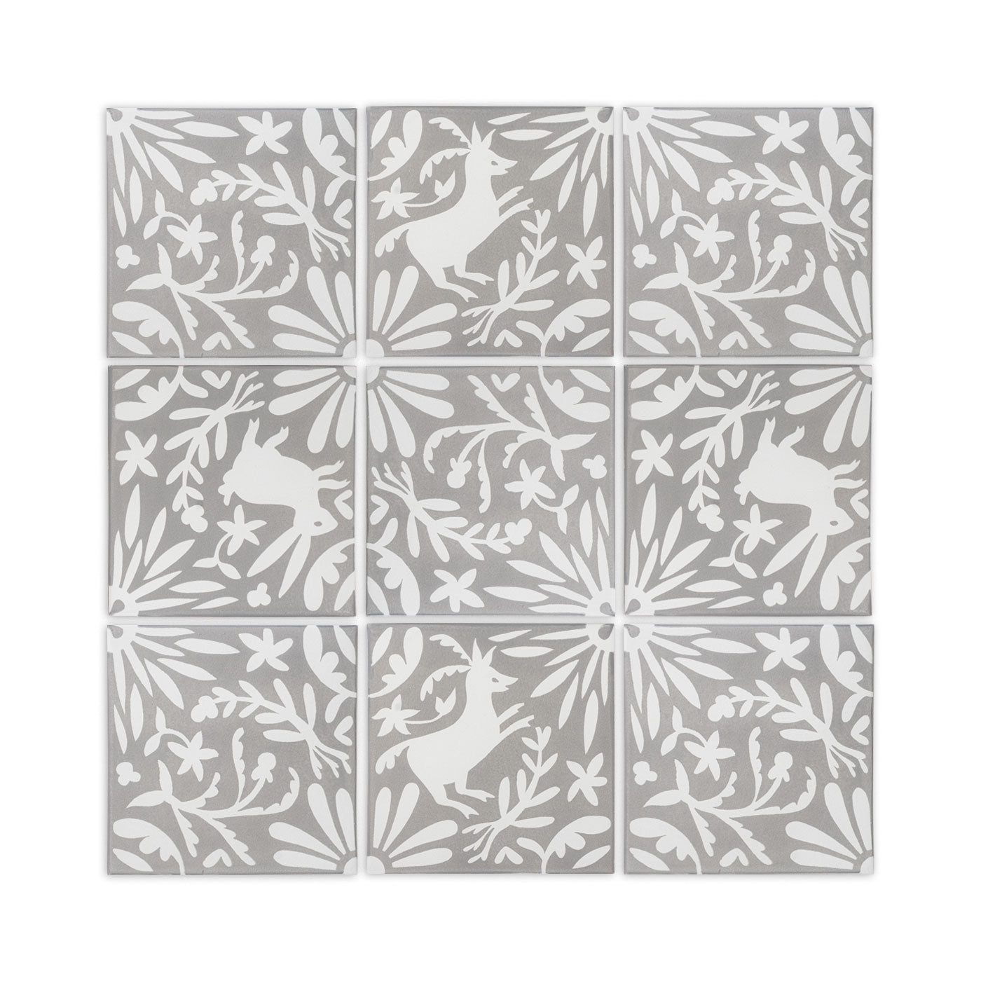 Grey and white pattern tile by Clay Imports, featuring white deer and rabbit figures among floral and starburst designs.