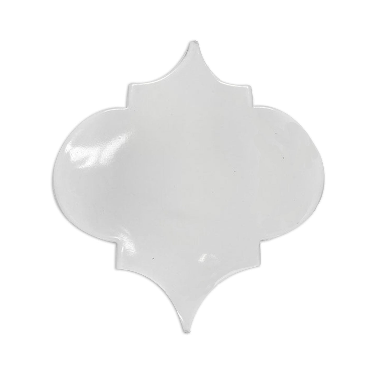 White glazed Fleur tile by Clay Imports, showcasing its unique arabesque shape and glossy finish.