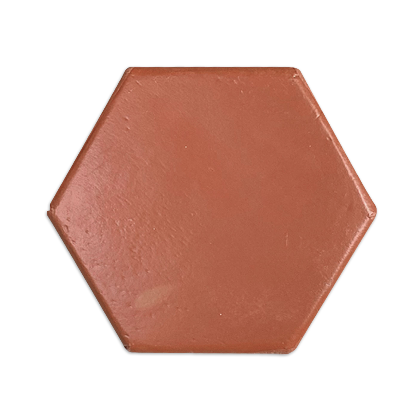 Red terracotta hexagon tile sample by Clay Imports, featuring a matte, textured surface on a white background.