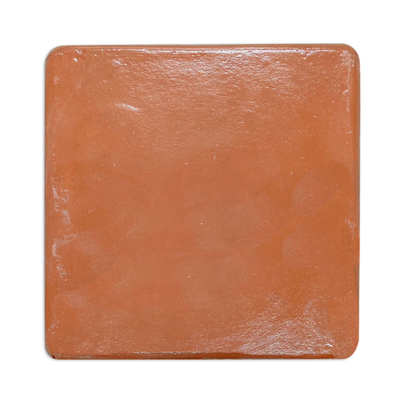 Terracotta gloss tile by Clay Imports, square with rounded corners and subtle surface imperfections.