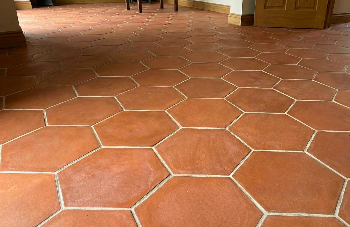 Terracotta hexagon tiles by Clay Imports covering a floor with light grout lines.