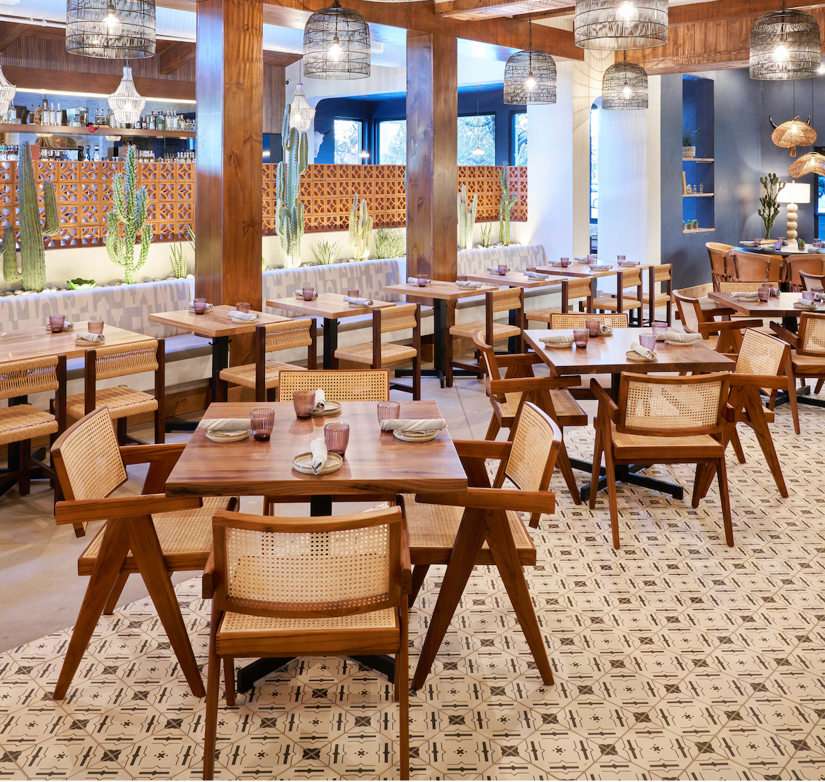 Nakbe Tobacco patterned floor tiles by Clay Imports, featuring a light geometric design in a restaurant setting.