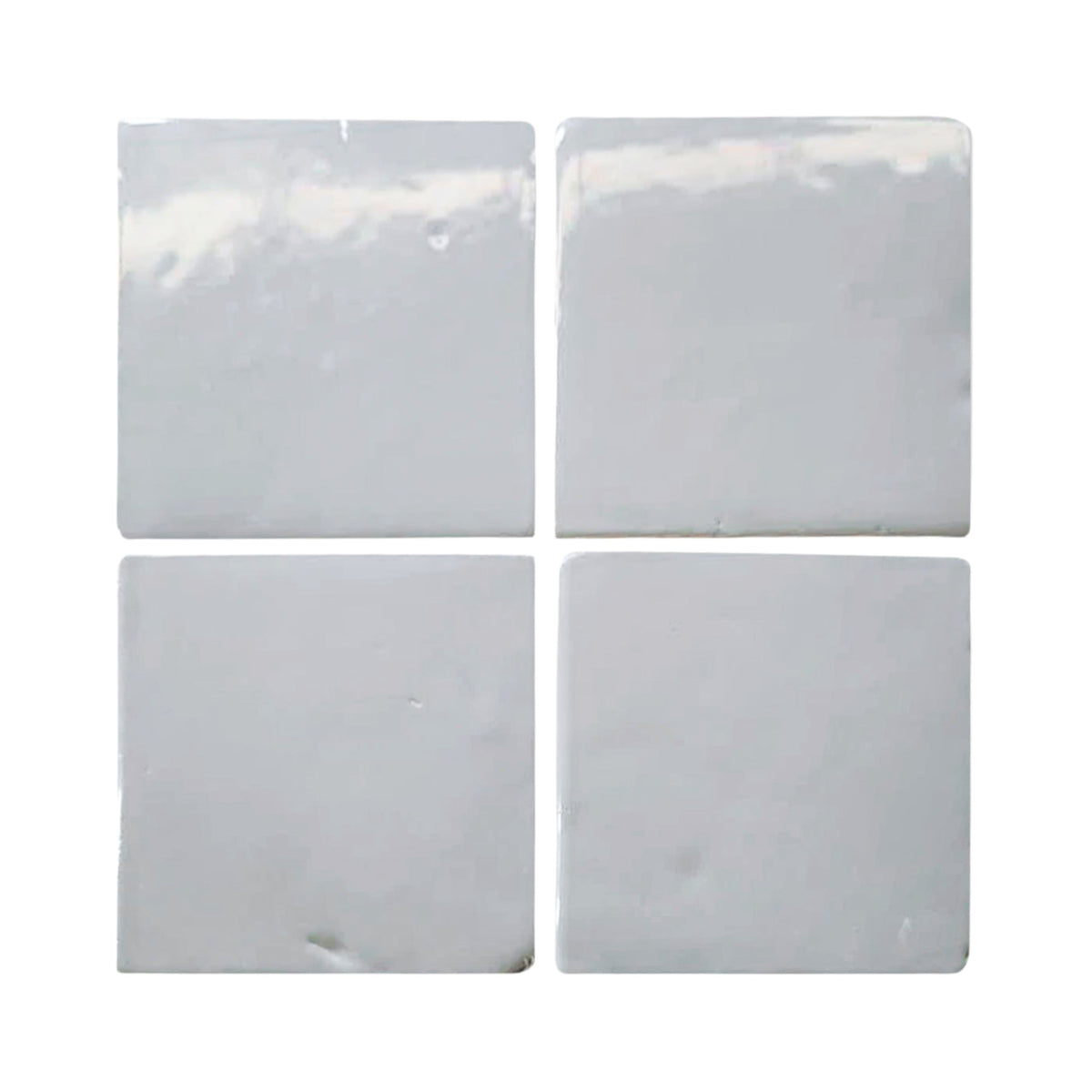 Four glossy white square tiles display a smooth, reflective surface against a plain white background.