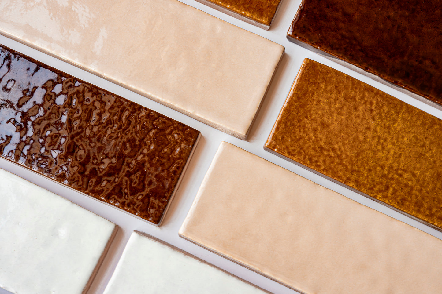 Glazed Thin Brick in apricot, brown, and white colors by Clay Imports, featuring varied glossy and textured finishes.