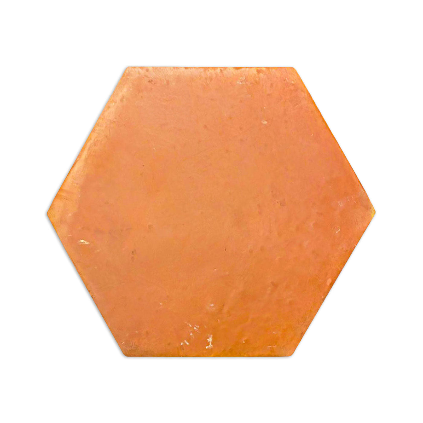 Orange hexagon tile with a smooth, satin finish by Clay Imports Saltillo Tile, showing natural variations and a subtle shadow.