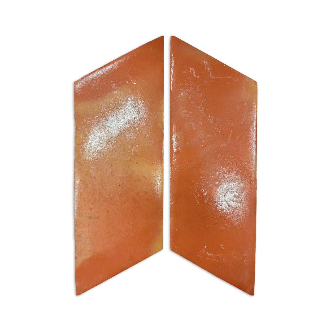 Two orange-brown parallelogram smooth gloss tile samples by Clay Imports, with subtle yellow-orange variations, separated by a gap.