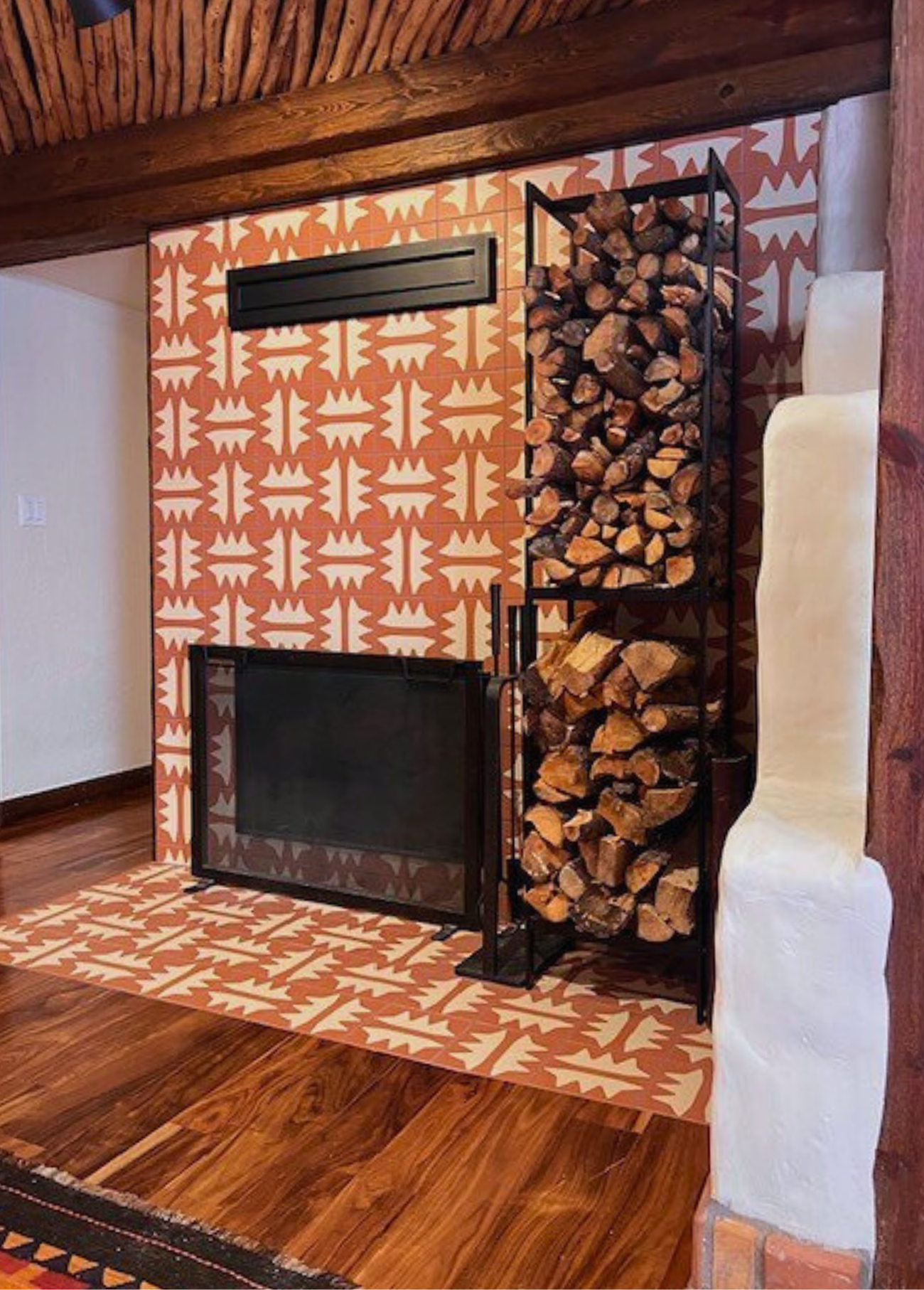 Terracotta and cream pattern tile by Clay Imports, featuring an intricate repeating geometric pattern, adorning a fireplace and hearth.