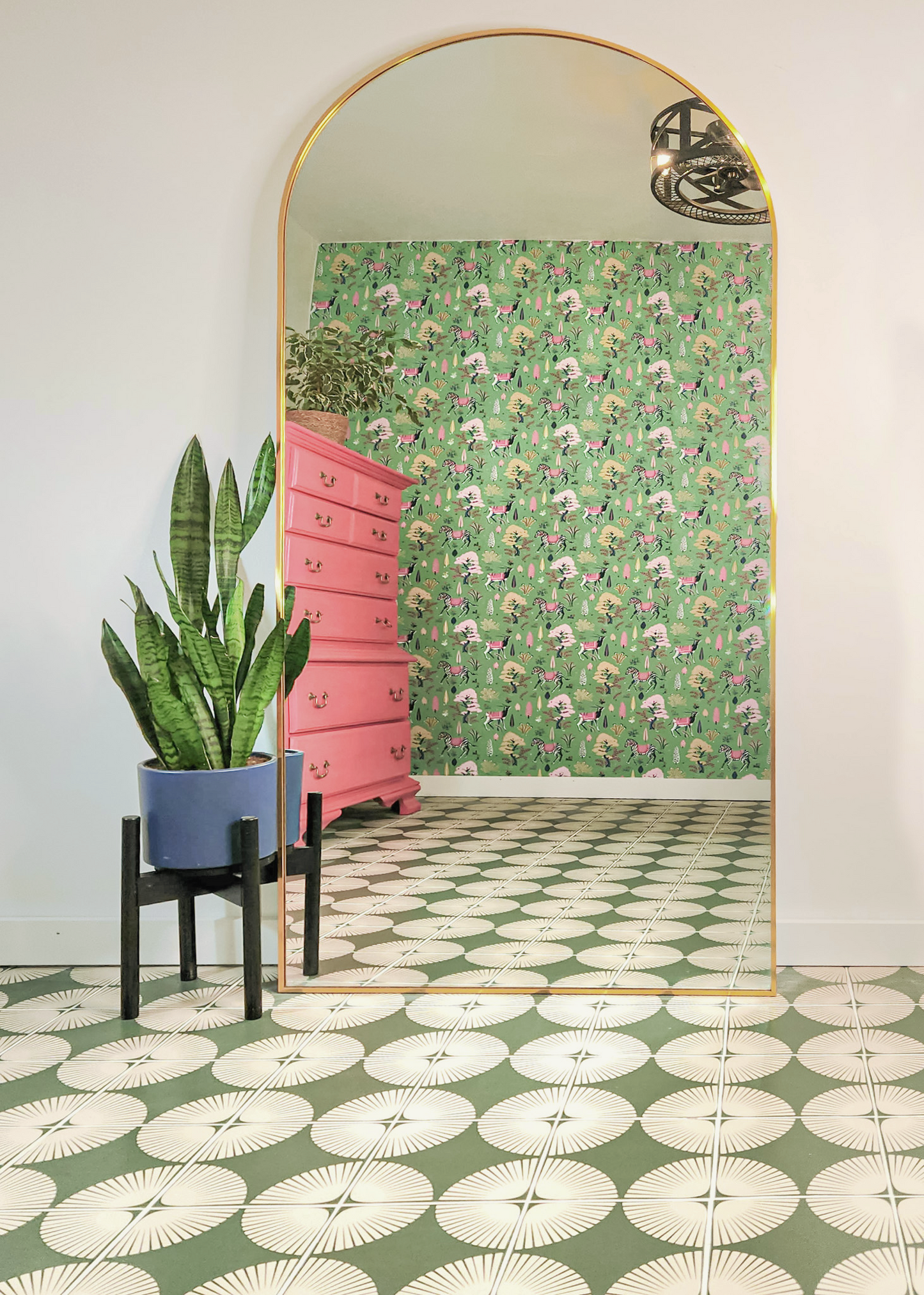 Green and white petal pattern tile by Clay Imports, featuring a striking circular motif on a floor.