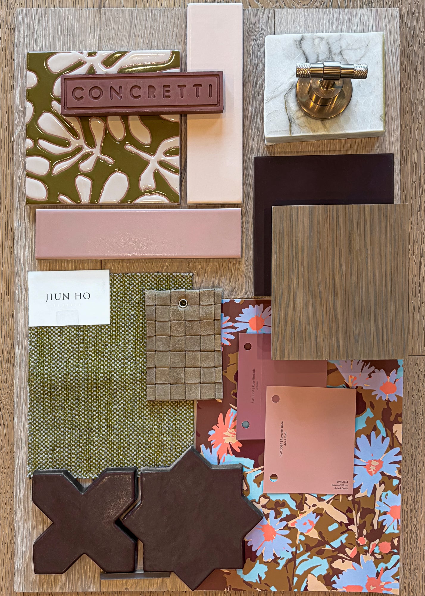 Patterned concrete tile samples from Clay Imports, featuring green and white organic motifs and brown geometric shapes, presented on a design mood board.