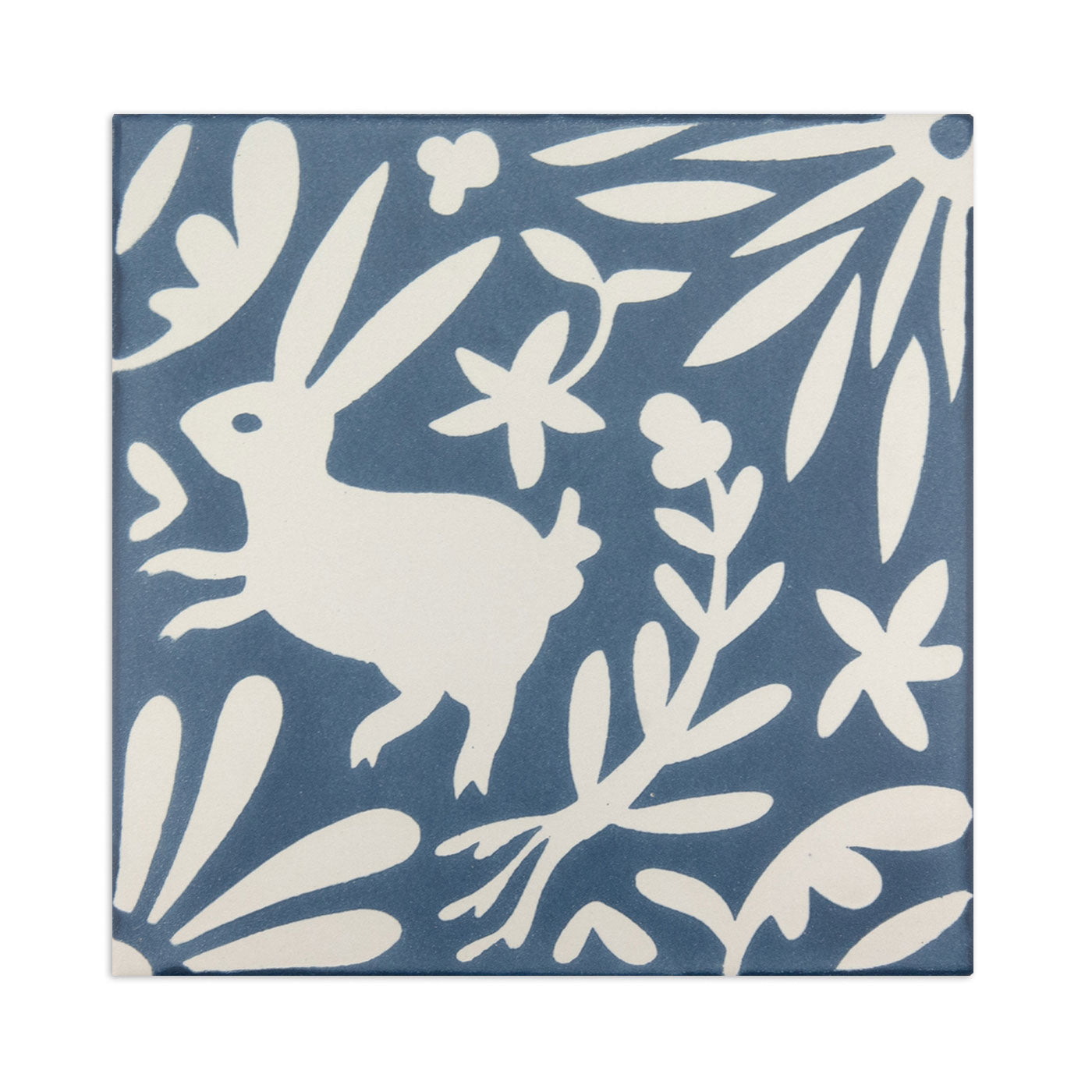 Blue and white sample tile by Clay Imports featuring a white rabbit and floral pattern.