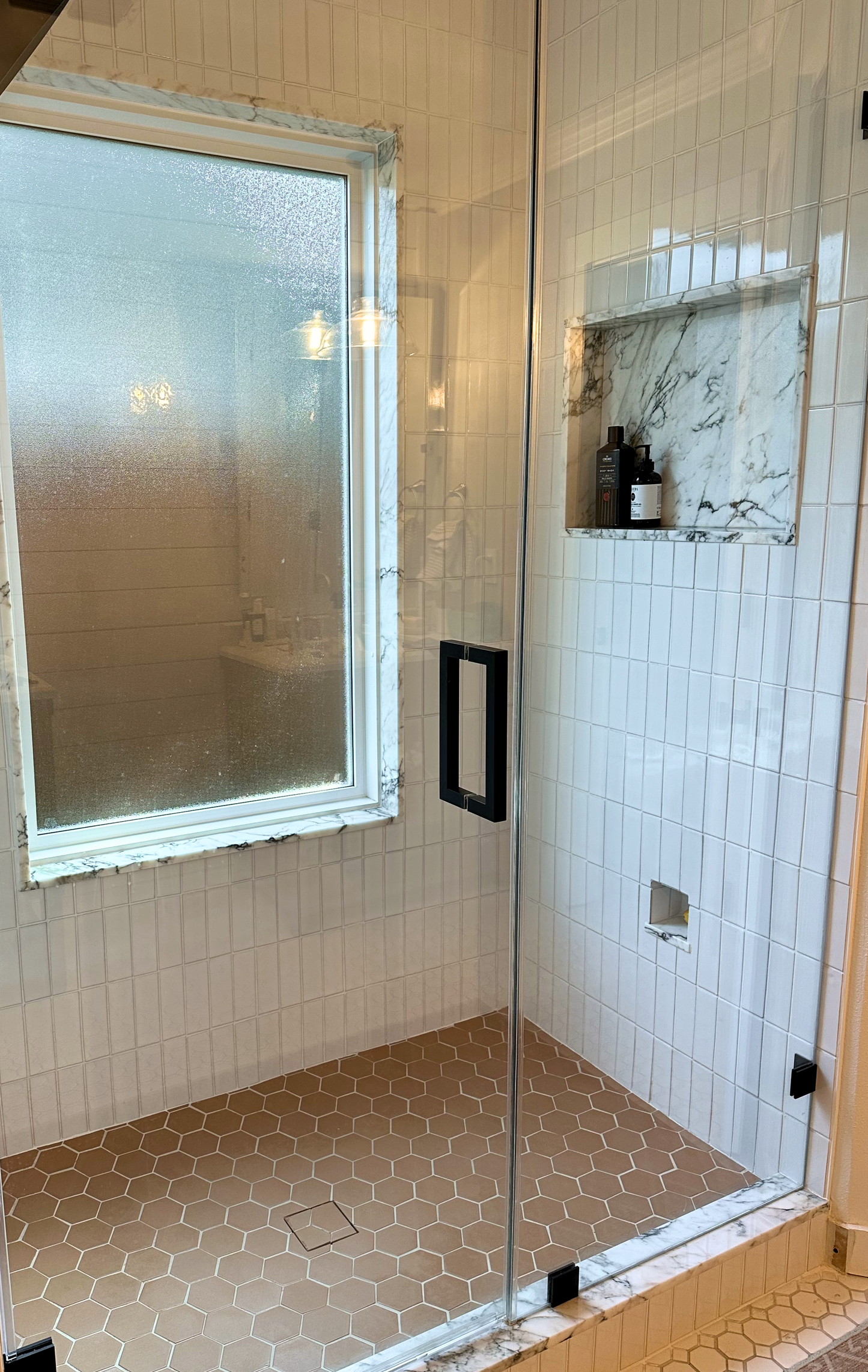 Light cream solid tiles by Clay Imports in a vertical rectangular pattern with thin white grout on a shower wall.