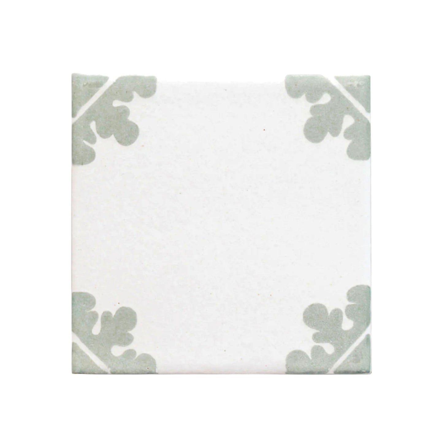White Talavera tile sample with sage green agave leaf patterns by Clay Imports Handmade Tile.