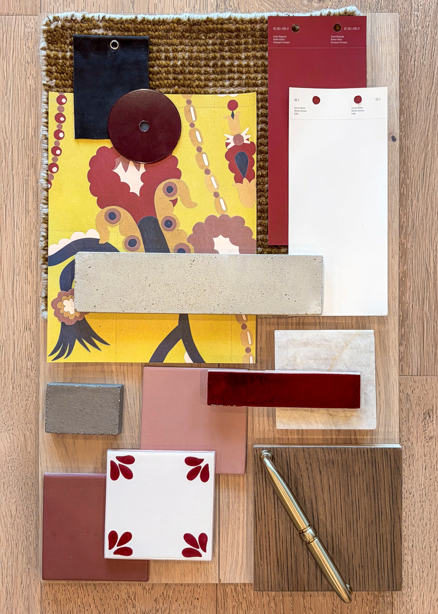Etch Design samples by Clay Imports, a mood board featuring yellow fabric, burgundy and white tiles, concrete, marble, and wood elements.