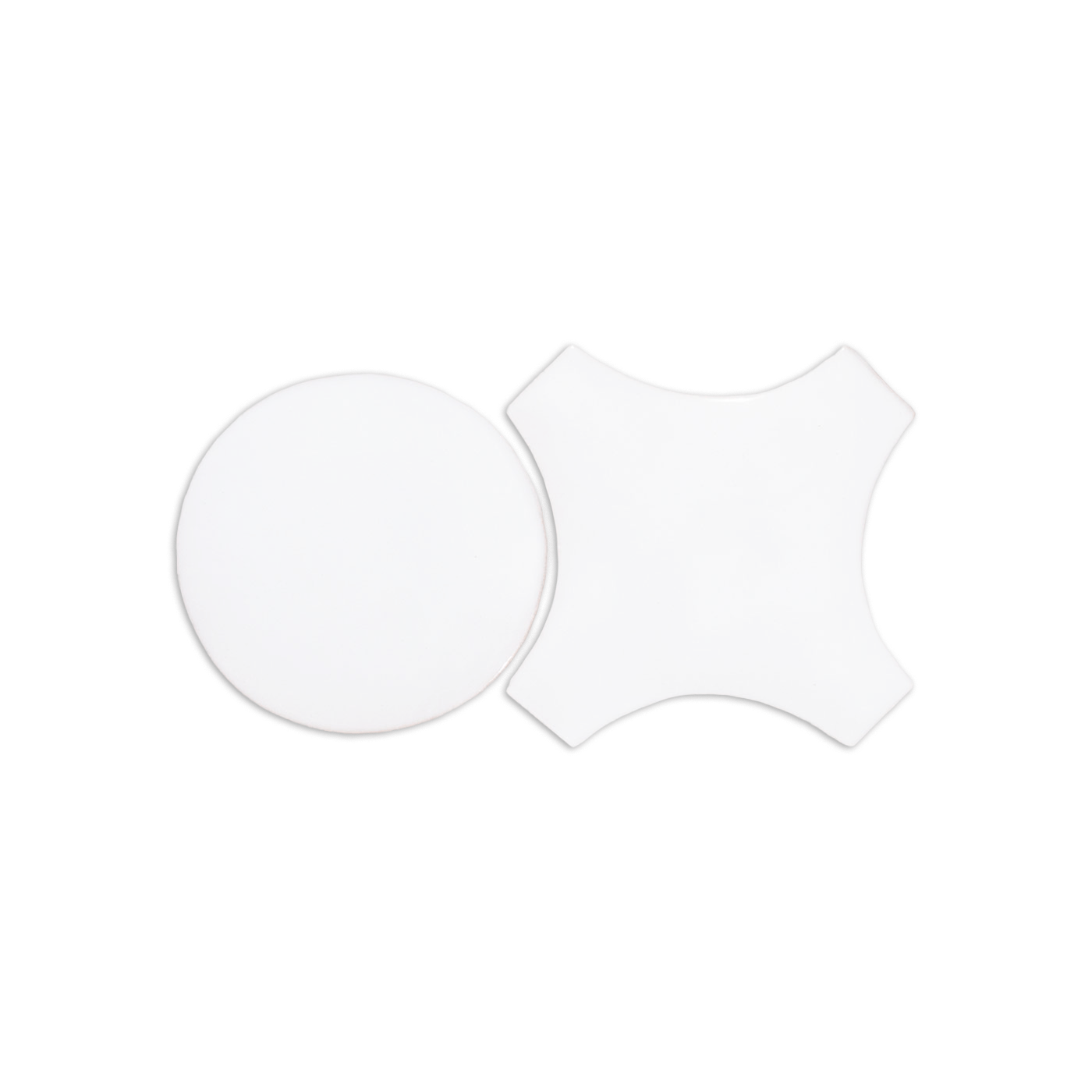 White sample tiles by Clay Imports, featuring one round and one path-shaped piece.