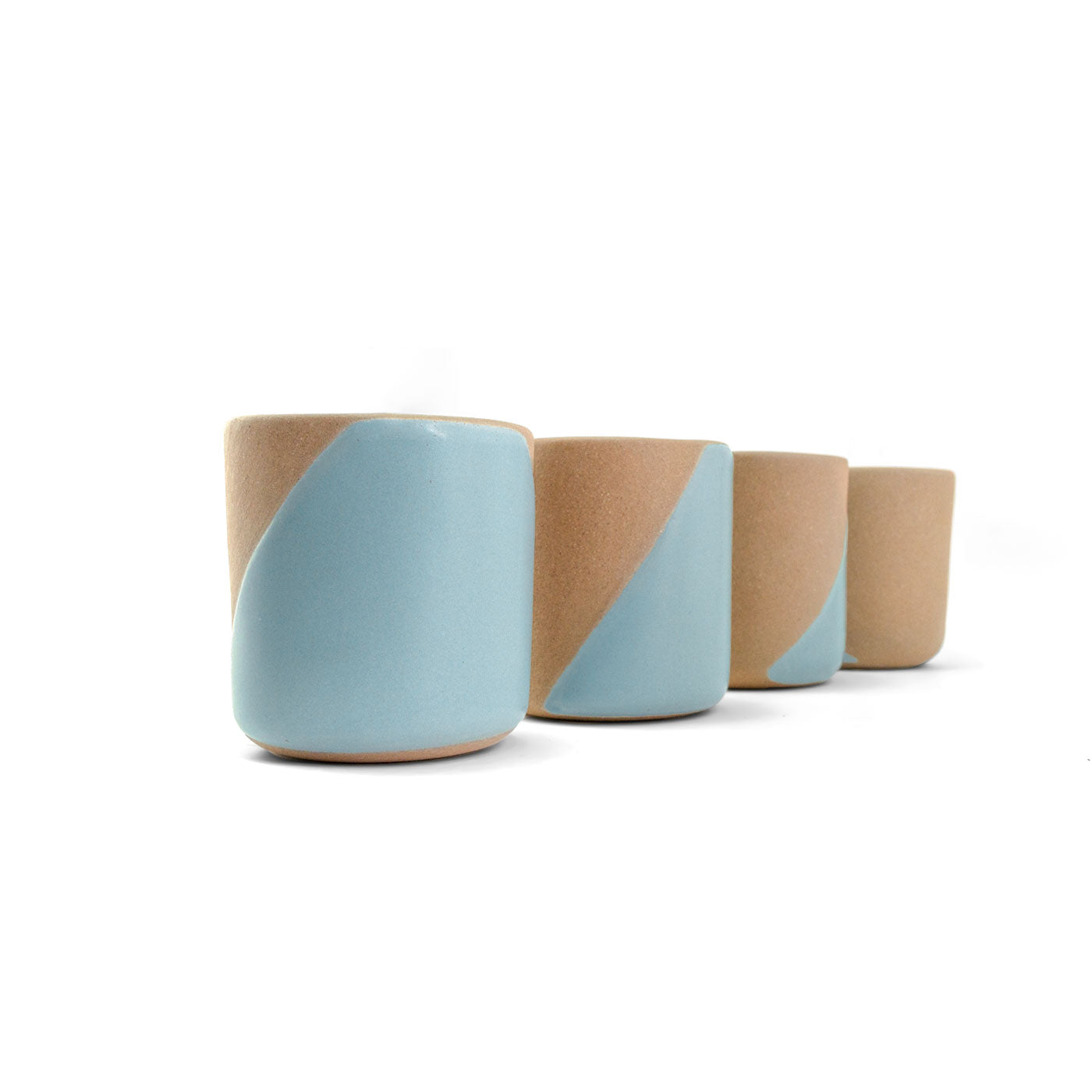 Four clay copitas by Clay Imports, two-toned with light blue and tan diagonal pattern, lined up on a white background.