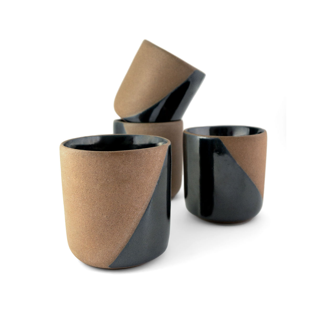 Clay copitas, brown and black by Clay Imports, featuring a diagonal black glaze on textured brown clay, some stacked.