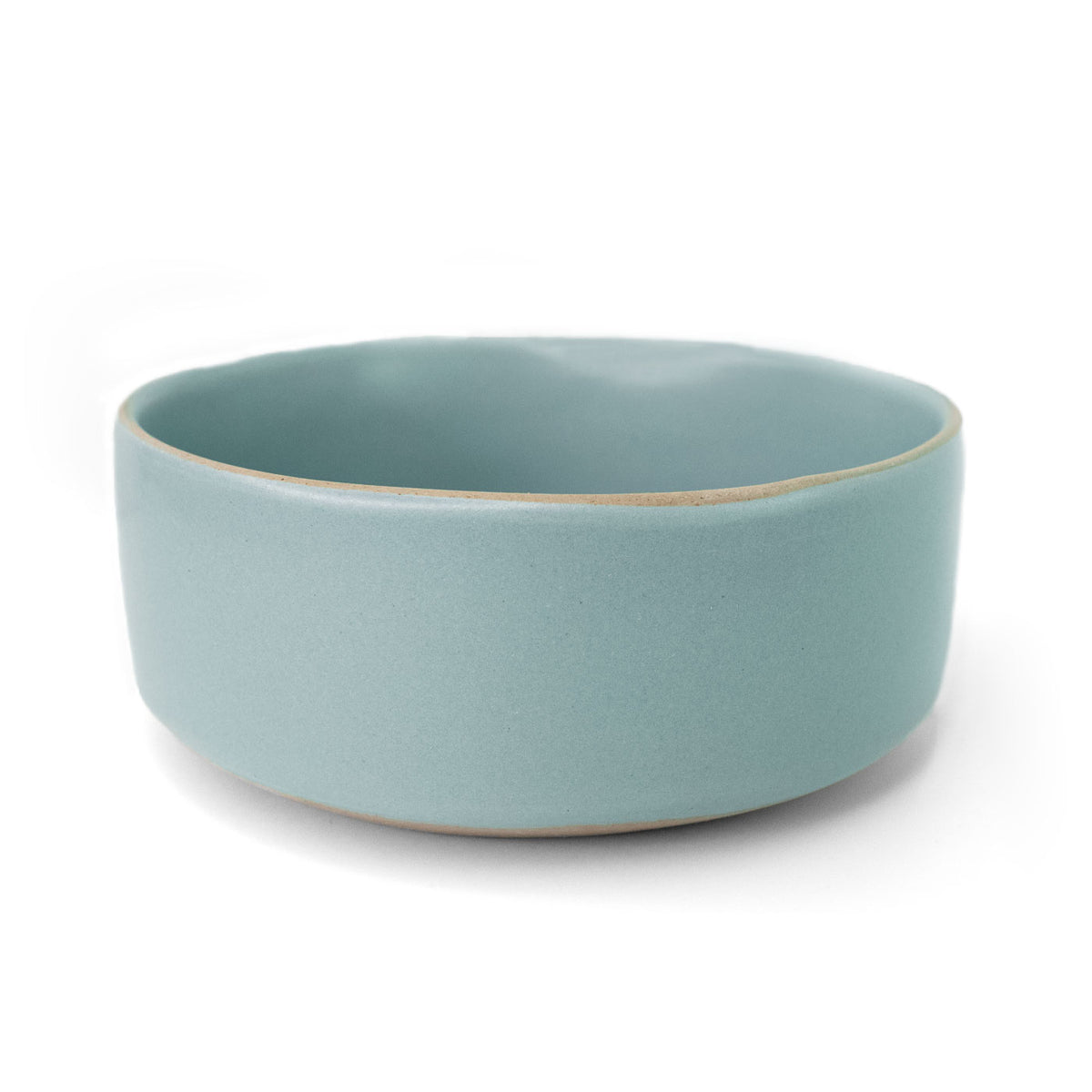 Light blue ceramic bowl by Clay Imports with a contrasting unglazed rim, shown from a side view.