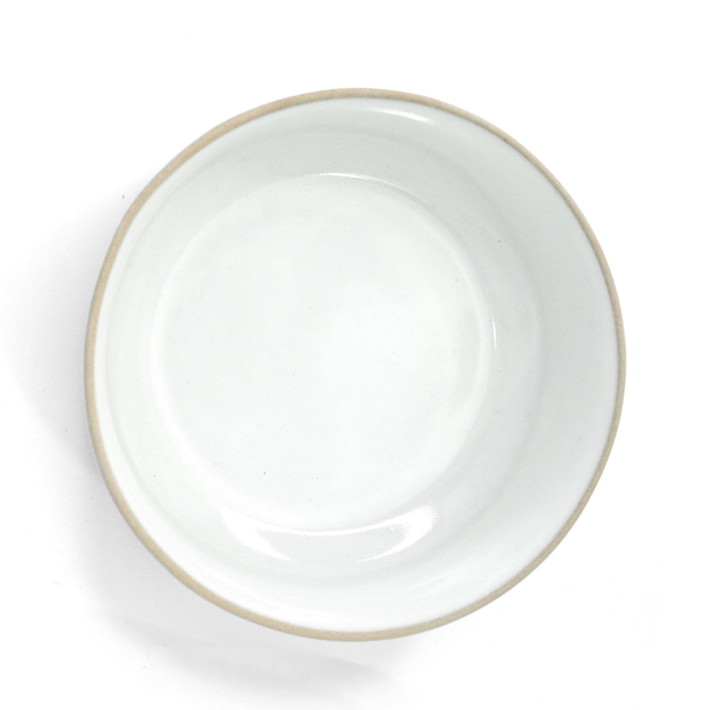 White clay bowl by Clay Imports with a natural unglazed beige rim, viewed from above.