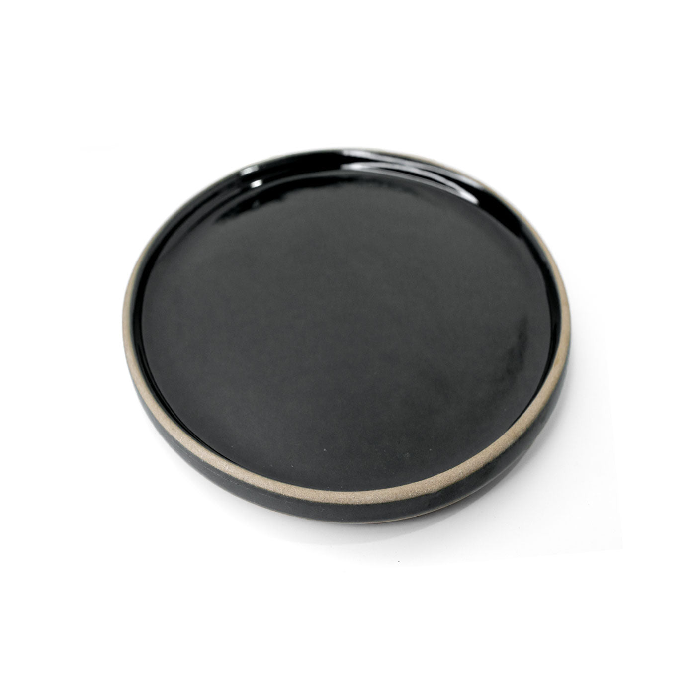Black round snack plate by Clay Imports with a glossy finish and an unglazed beige rim.