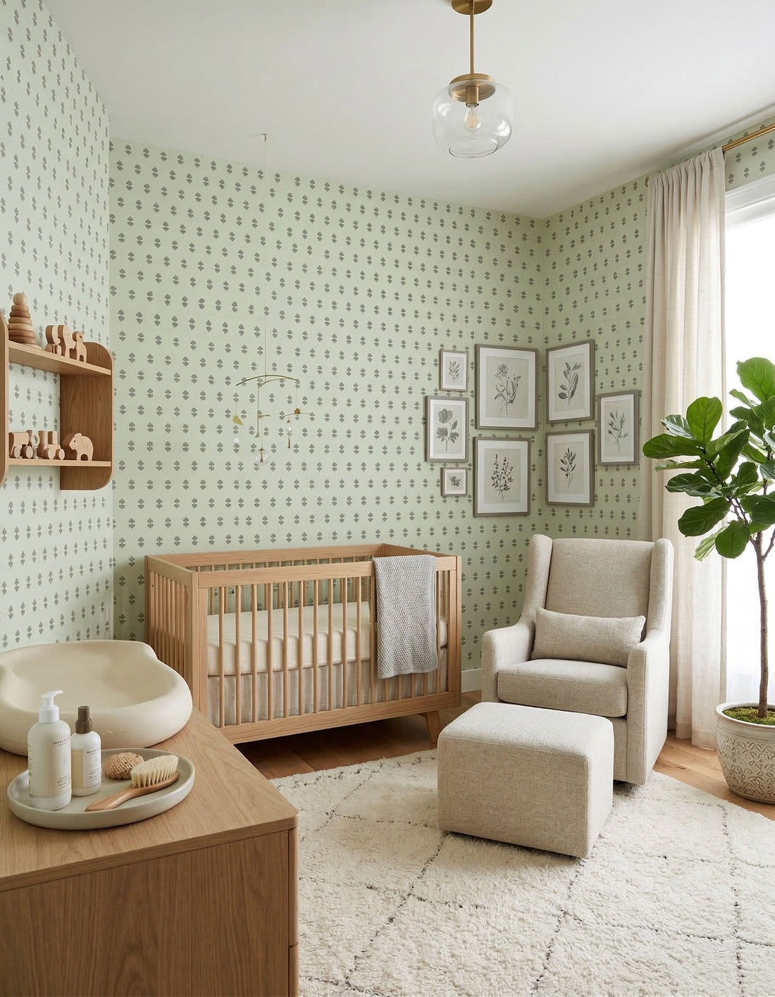 A gentle nursery with light green wallpaper featuring a subtle organic pattern, a wooden crib, and a comfortable reading nook.