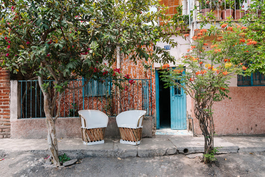 Mexican Equipale chairs in front of a Mexican home clay imports