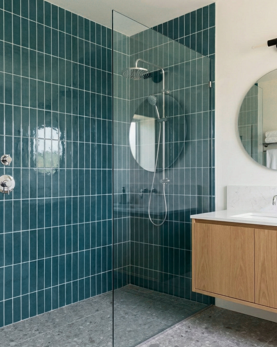 Serene modern bathroom featuring lush botanical teal tiles, a walk-in shower, and a sleek wood vanity, ideal for a tranquil escape.