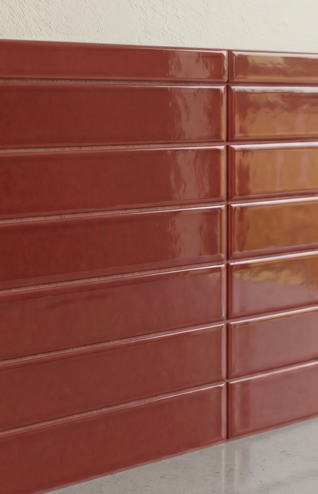 Rich, glossy terracotta brick-style trim tiles with textured grout, evoking a warm, desert-inspired contemporary design.