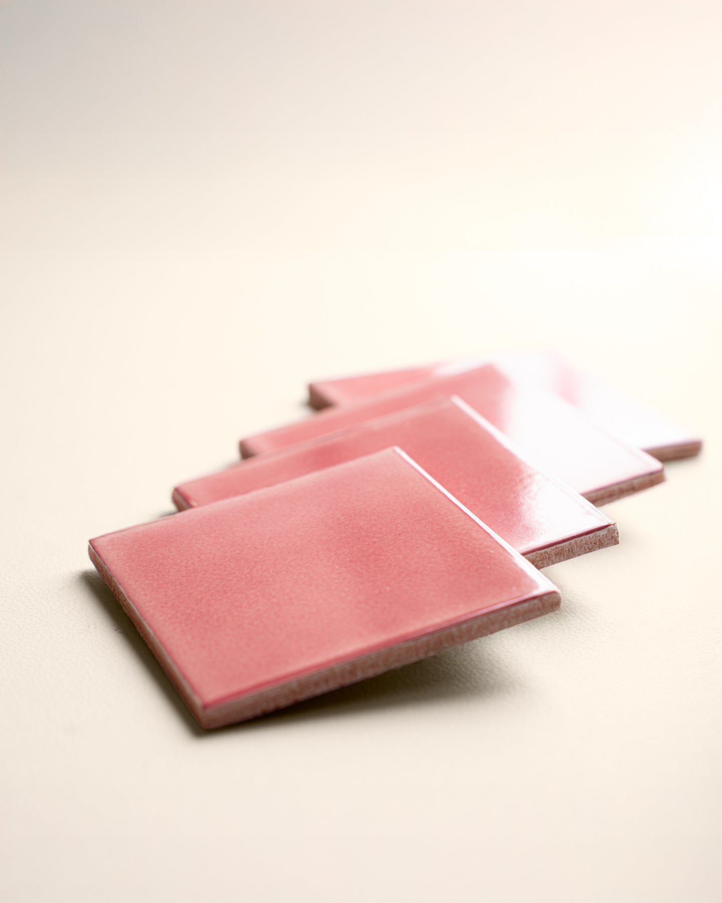 Artisanal pink handcrafted tiles, subtly textured with a beautiful, unique glaze for warm, inviting spaces.