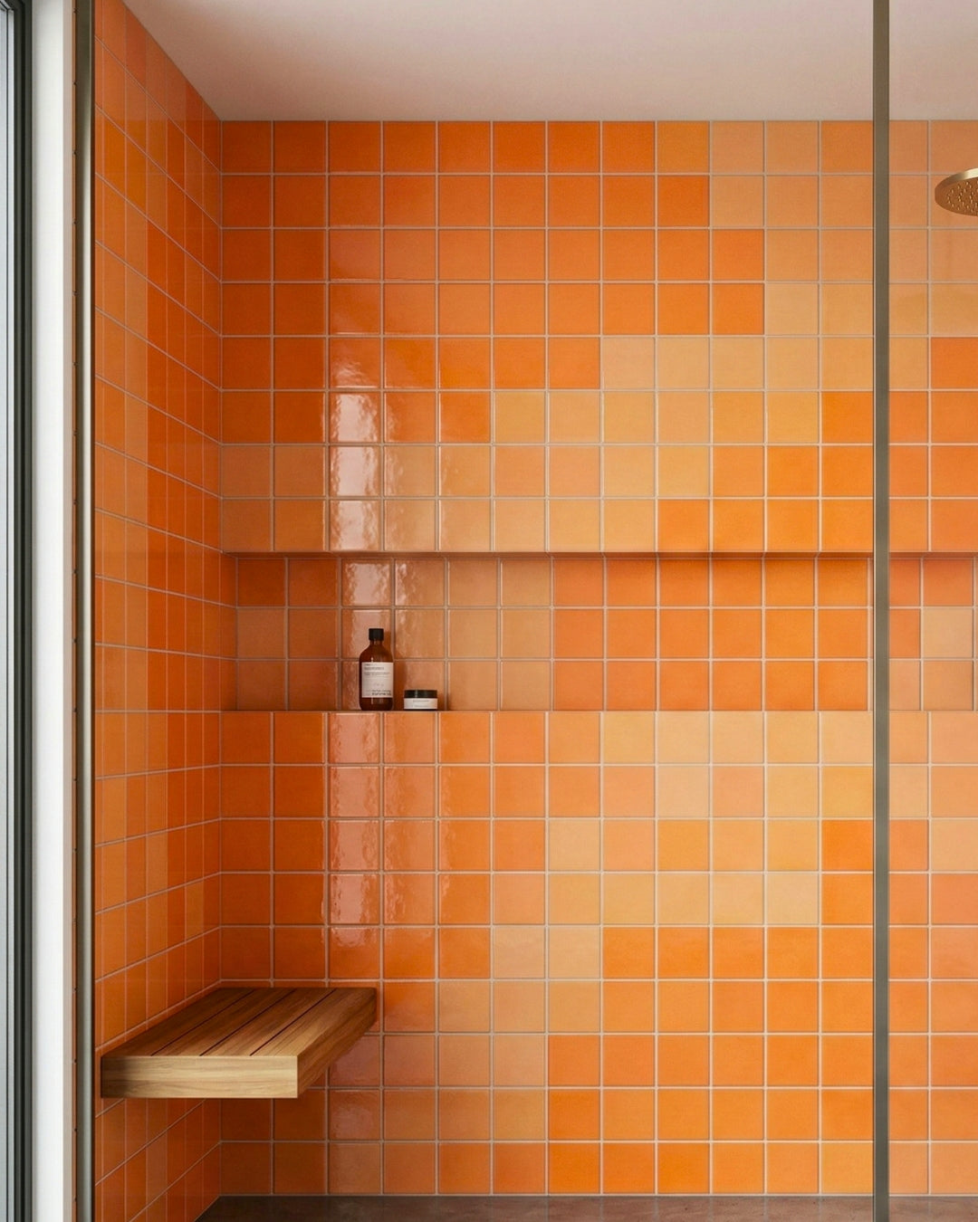 Vibrant orange tiled shower with a wooden bench and shelf, capturing the Sherbet collection's refreshing, modern, and cheerful aesthetic.