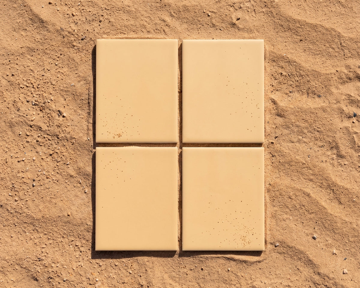 Matte Sandbank Solid Tile by Clay Imports, a set of four rectangular tiles on a textured white surface.