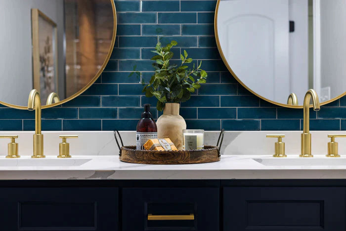 two mirrors with blue tile as background of a bathroom