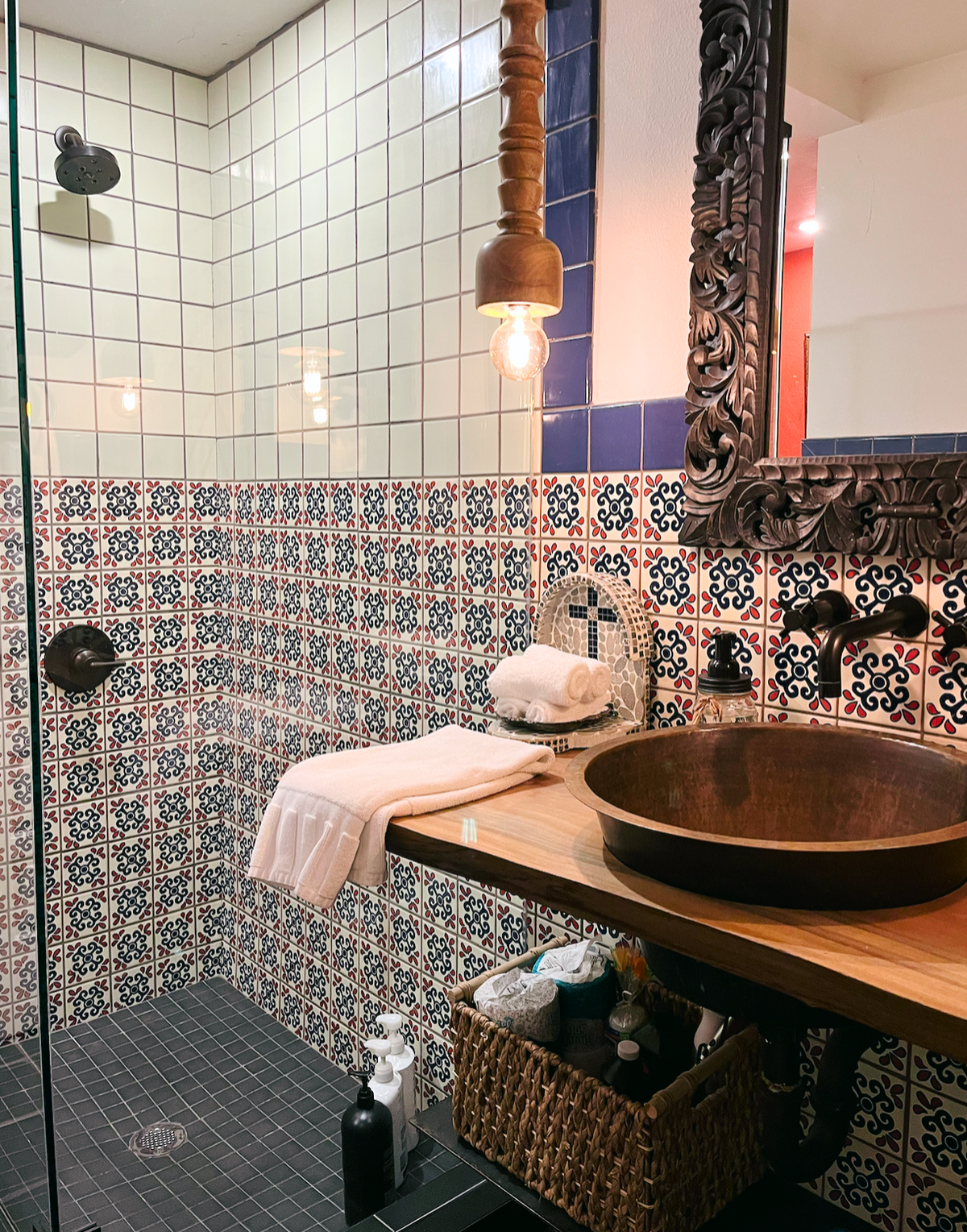 Blanco Mexicano 6x6 clay tiles by Clay Imports, displaying white, red, and blue intricate patterns on a bathroom wall.