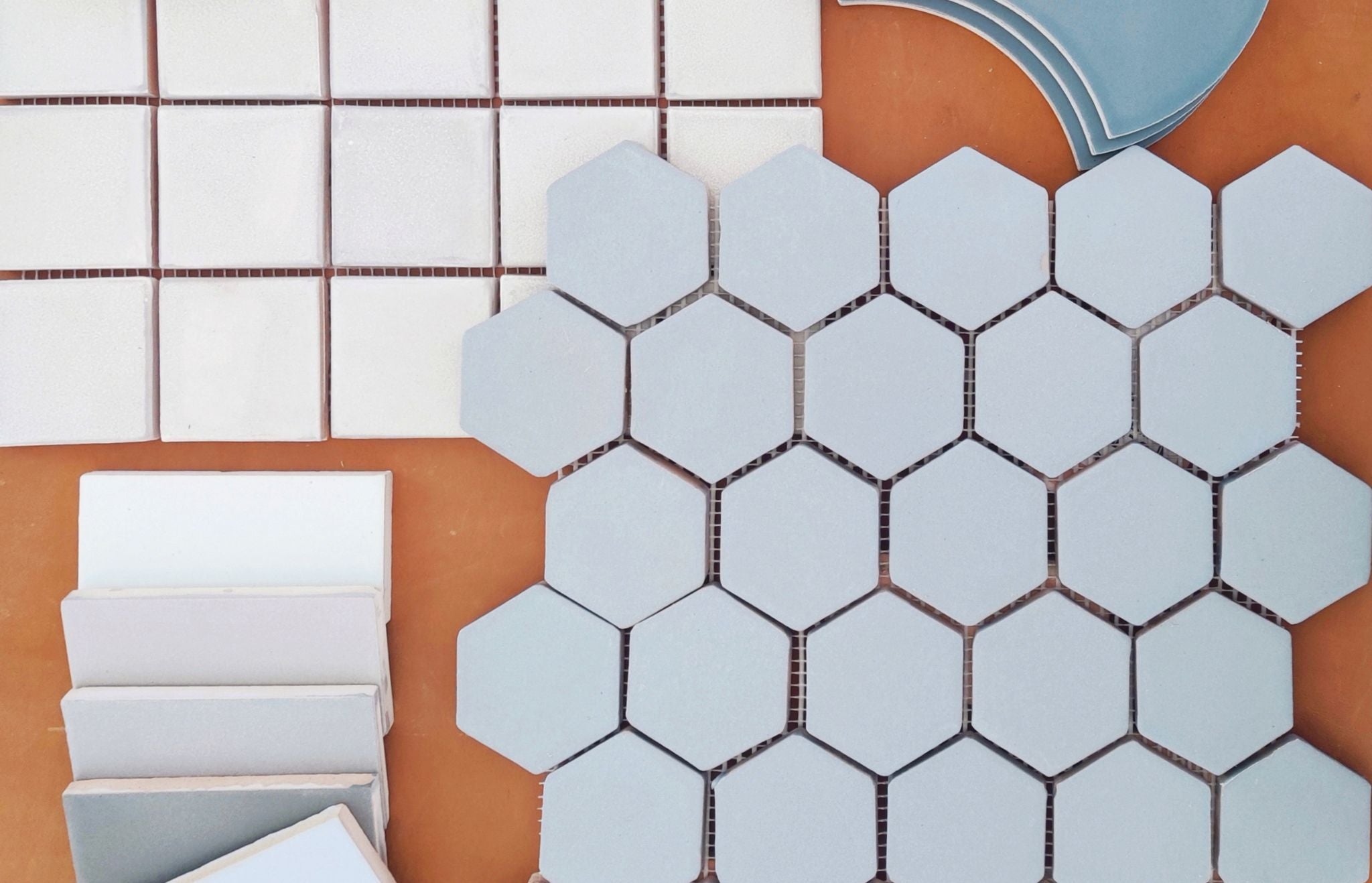 Diverse tile samples: white squares, light blue hexagons, stacked neutral rectangles, and curved blue accents for modern design.
