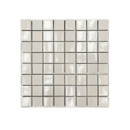 Light cream clay mosaic tiles by Clay Imports, showing glossy, square, handcrafted-style tiles on a mesh.
